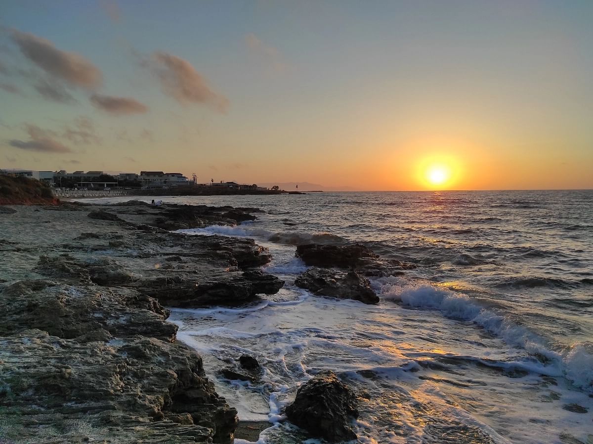A nice sunset in October at Gouves beach. Take in the stunning beauty of the sunset at Gouves beach in October as the sun gradually sinks below the horizon and wraps the landscape in a warm, vibrant glow.